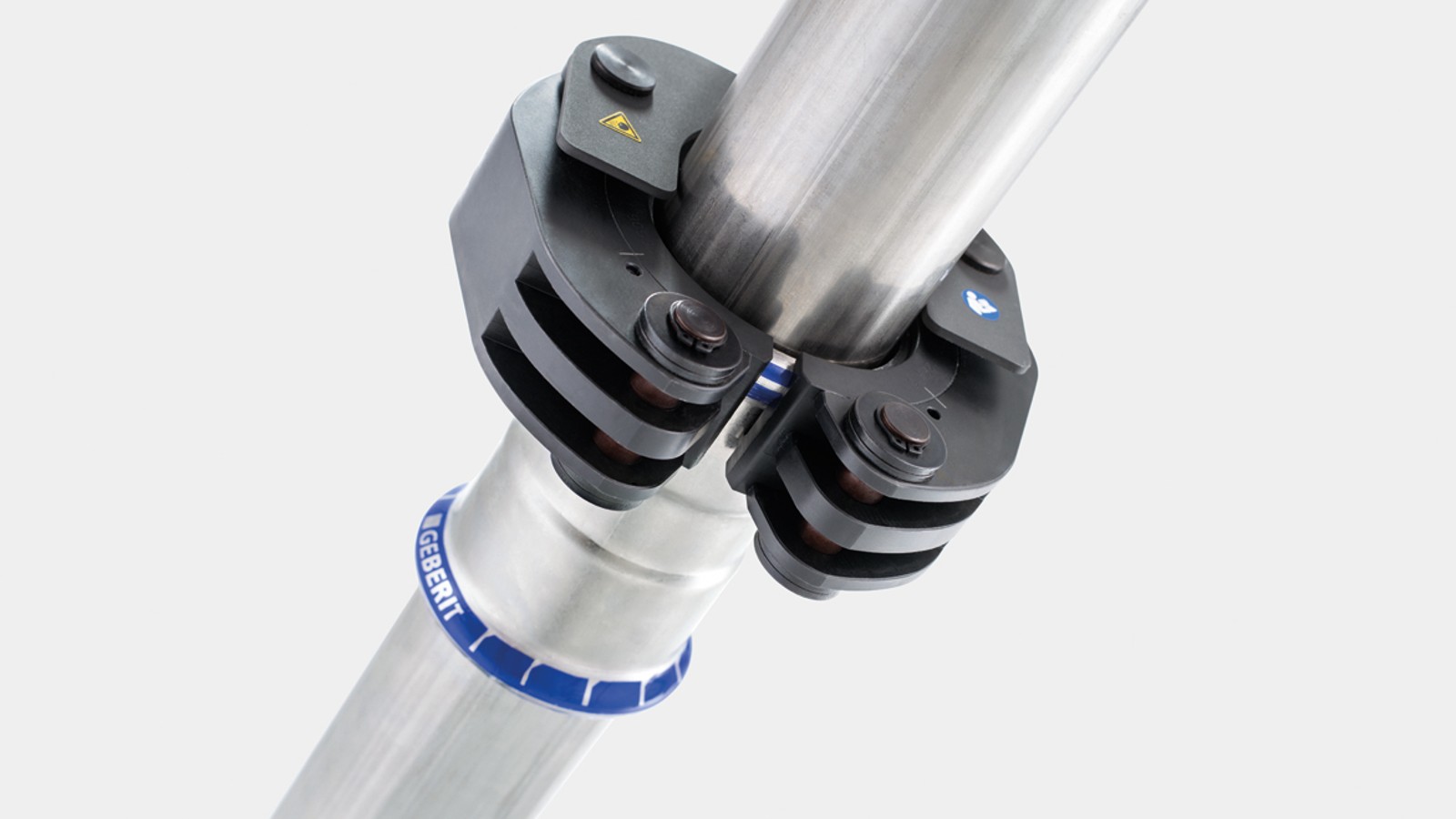 Klikkmekanismen fester Geberit press-slingene på Geberit Mapress fittingen